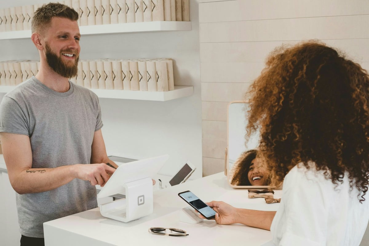 Customer paying in person at counter with digital payment