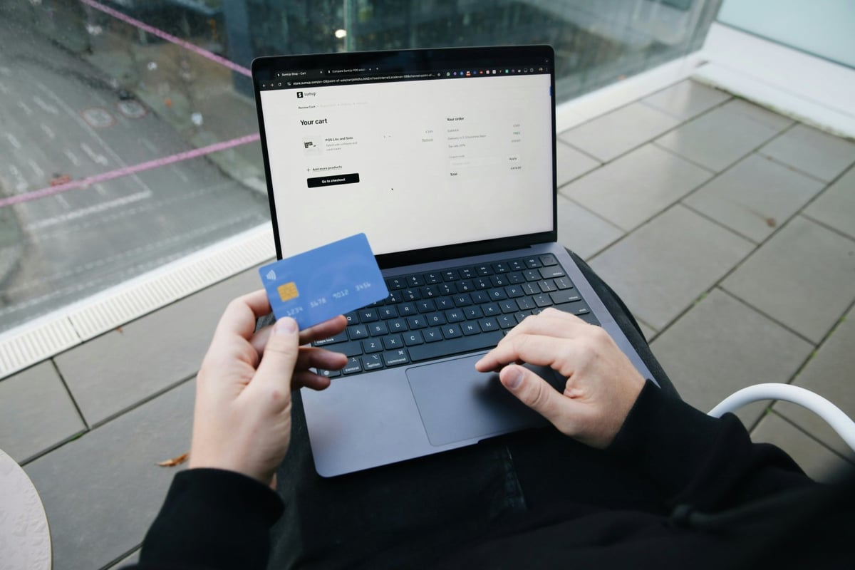 Small business owner managing online payments on laptop