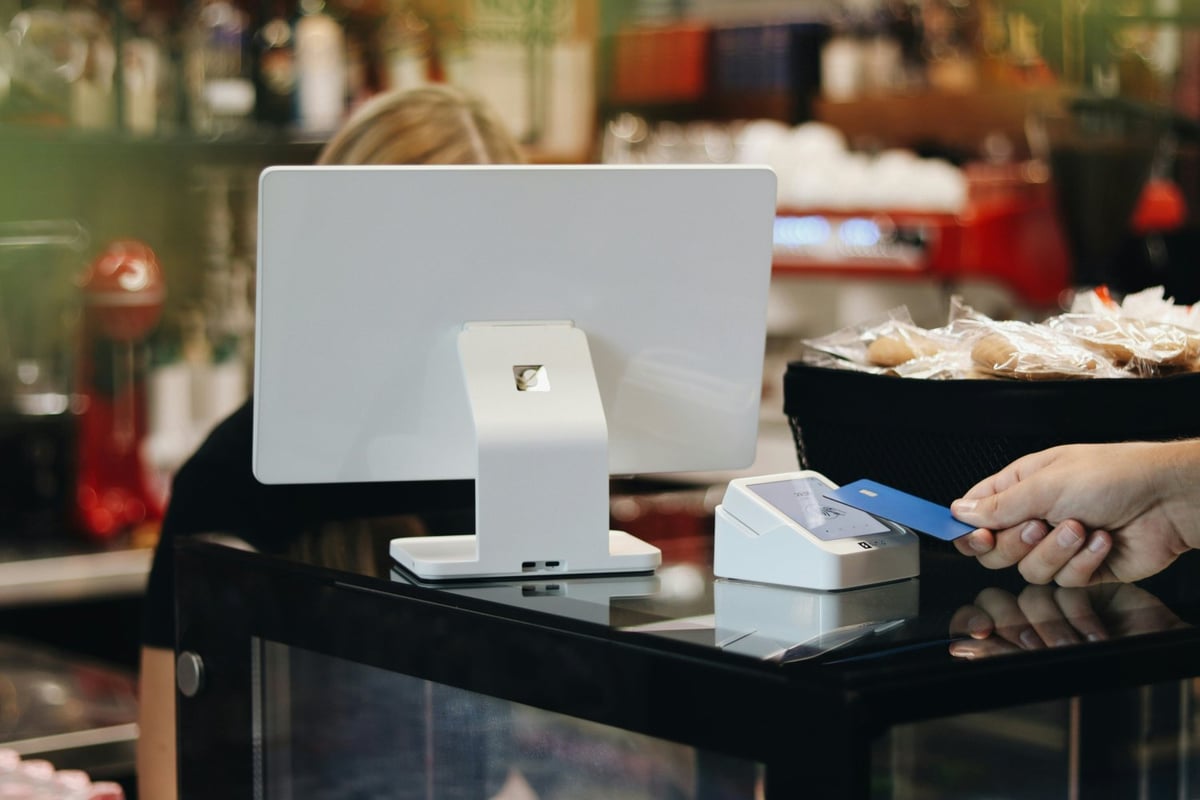 small business owner taking a card payment at a laptop